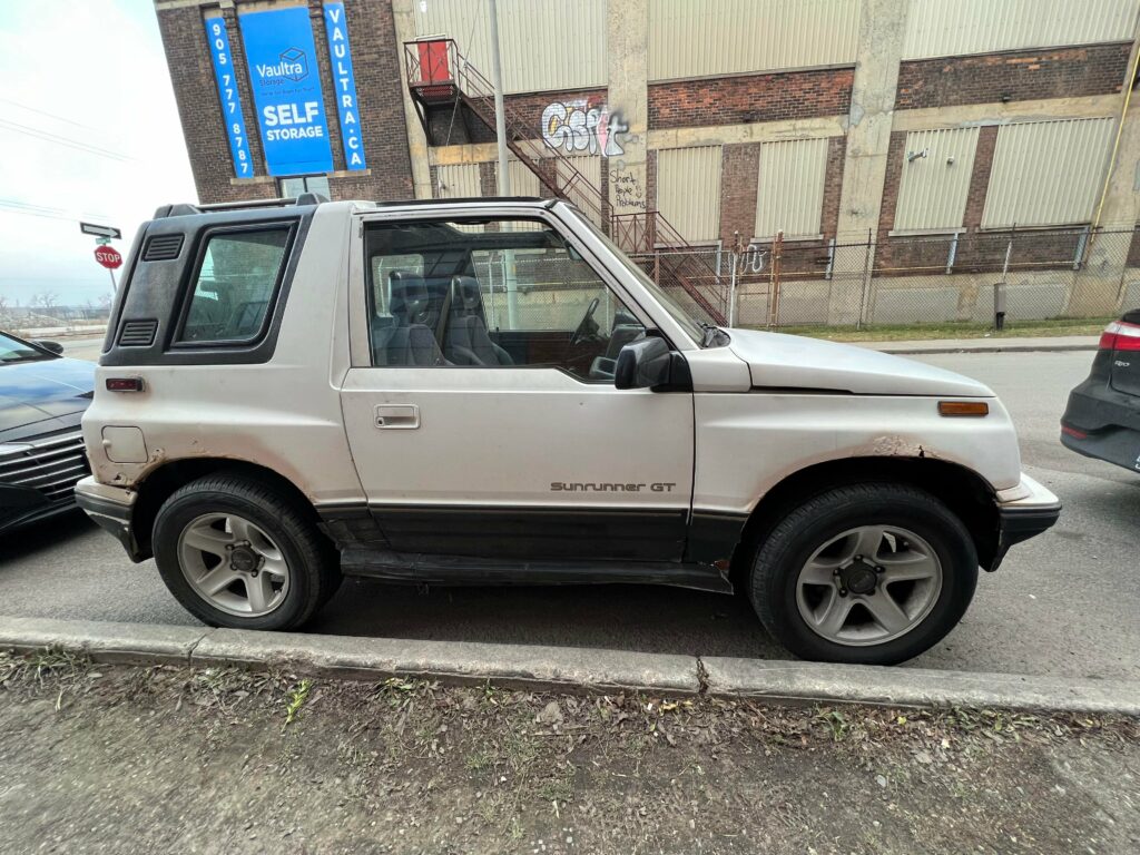 I spotted a [Pontiac Sunrunner GT] The Canadian version of the Geo/Chevy Tracker.