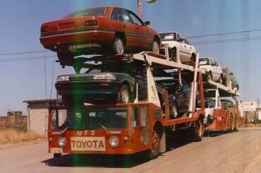UFO (Under Floor Operated) truck used to transport cars from the rail head to a storage facility. Bonus rebadged commodore.