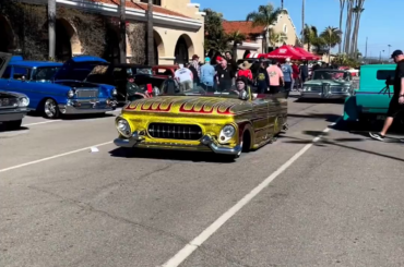 This gold car at a car show.
