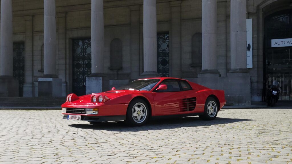 a [ferrari testarossa] outside 'autoworld' in brussels