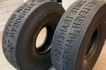 Literally weird wheels: tires on a tourist sightseeing truck made to "write" a poem in the sand it drives on