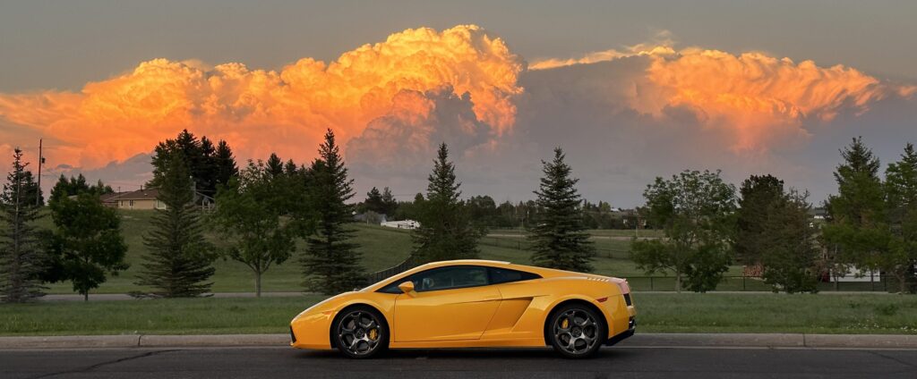 My Lamborghini Gallardo tonight at sunset with a storm in the background [3863x1598]
