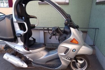 BMW C1. If you use the seatbelt you're allowed to ride without a helmet