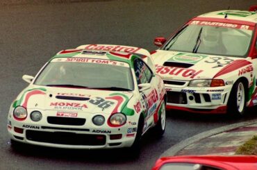 An Super Taikyu Celica GT-Four driven by the late Shingo Tachi followed closely by an Lancer Evolution IV.
