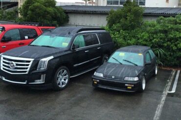 Honda Today next to a Cadillac Escalade
