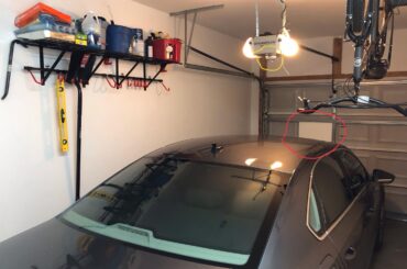 Yellow circle is an adjustable lazor beam. Red circle is a piece of styrofoam. Both placed by previous owner. What is its purpose? Is it a parking assist? What am I missing?