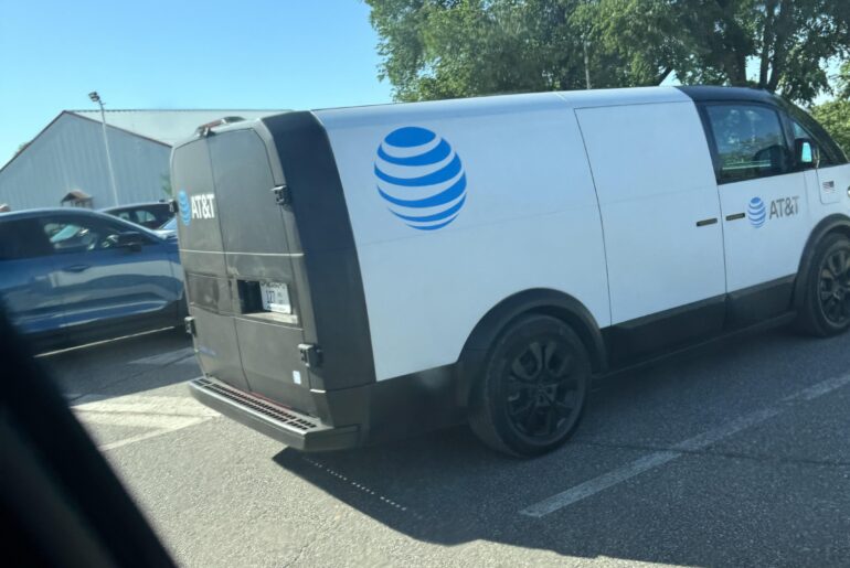 AT&T wrapped Canoo EV utility van in parking lot