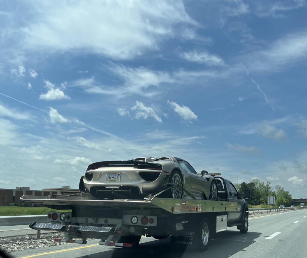 [Porsche 918 Spyder] left the Porsche dealership on a rollback, assuming it’s being delivered back to the owner after a service.