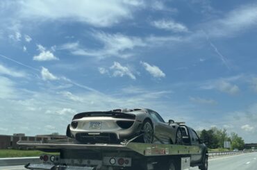 [Porsche 918 Spyder] left the Porsche dealership on a rollback, assuming it’s being delivered back to the owner after a service.
