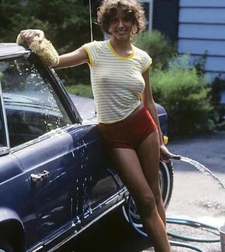 Model Luann Fernald washing a car, 1979