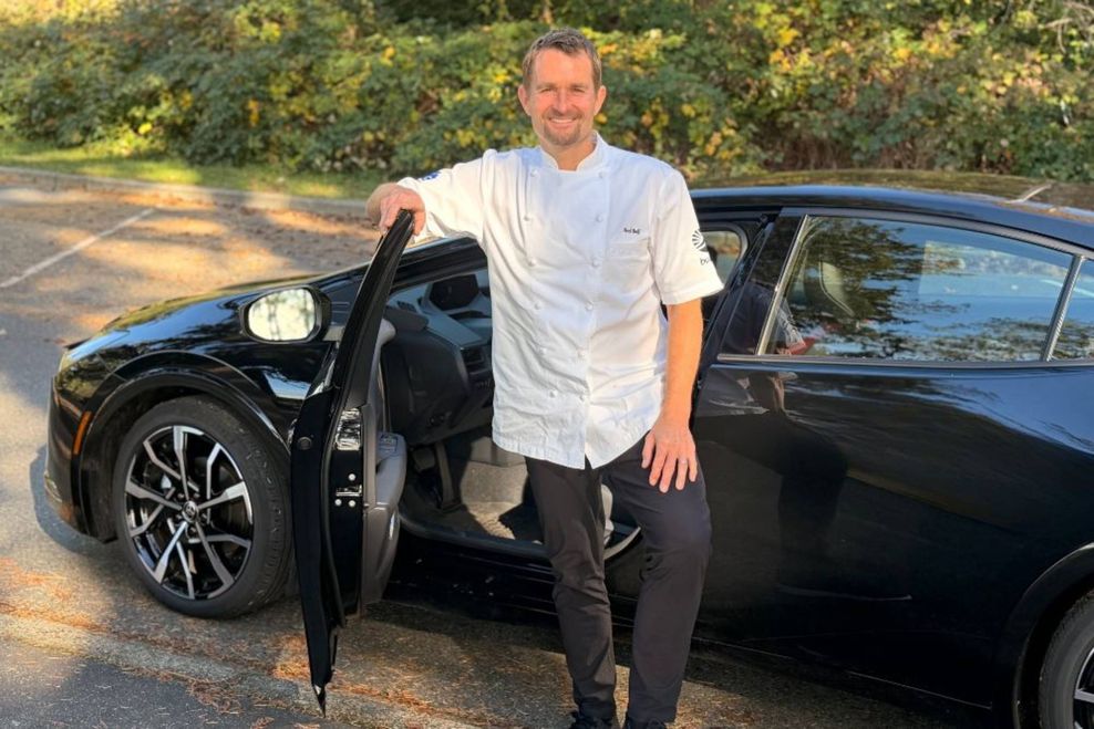 Ned Bell stands next to his Toyota Hybrid.