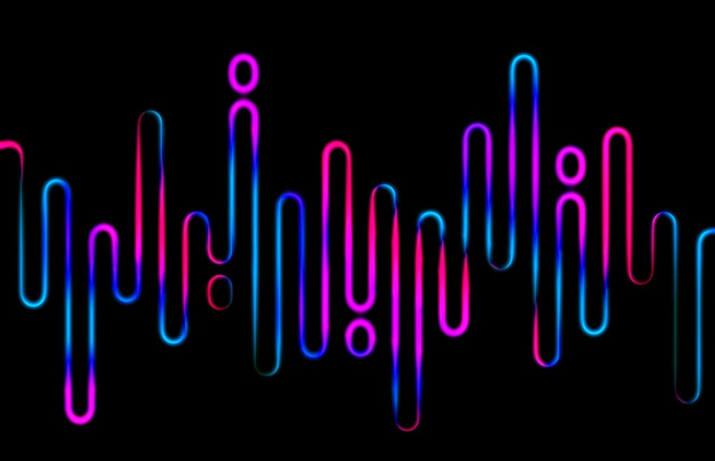Glowing pink and blue neon lines resembling soundwaves or equalizer bars on a black background, creating a modern, tech-inspired abstract.