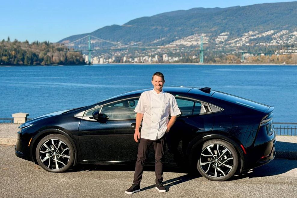Full body shot of Ned and his Toyota Hybrid.