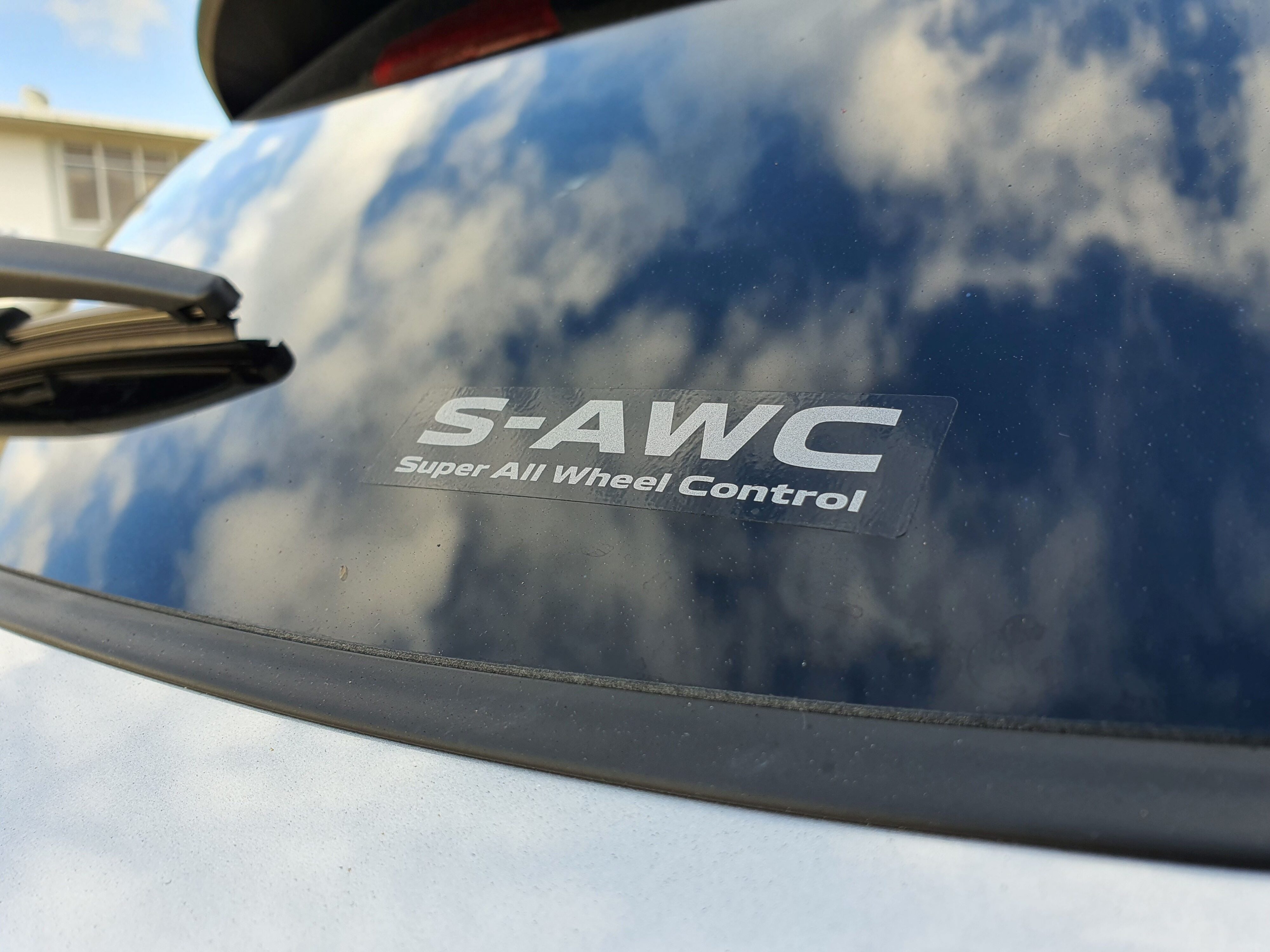 Photo of the S-AWC sticker on the back window of the 2025 Mitsubishi Outlander VRX PHEV. 