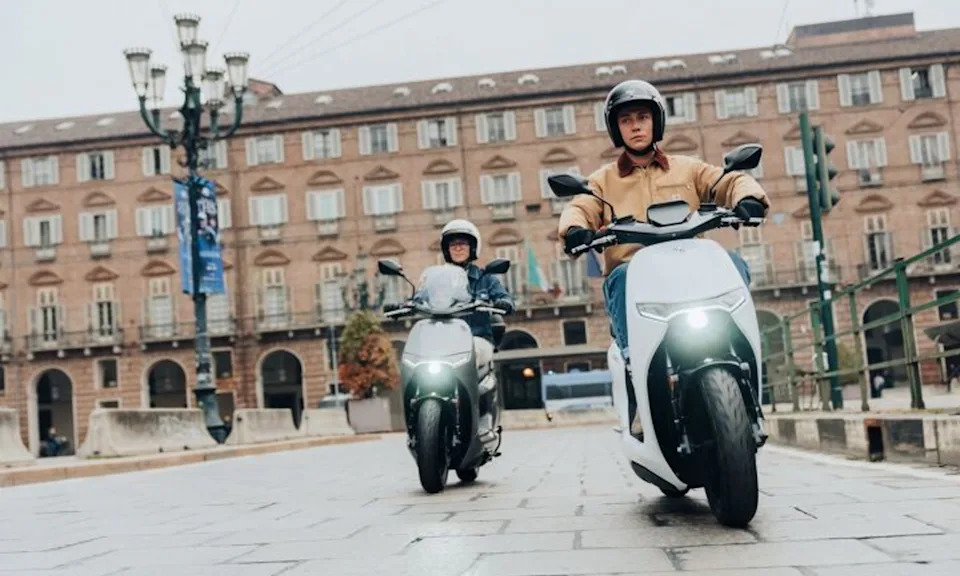 Two Zero LS1 electric scooters ridden in a European city.