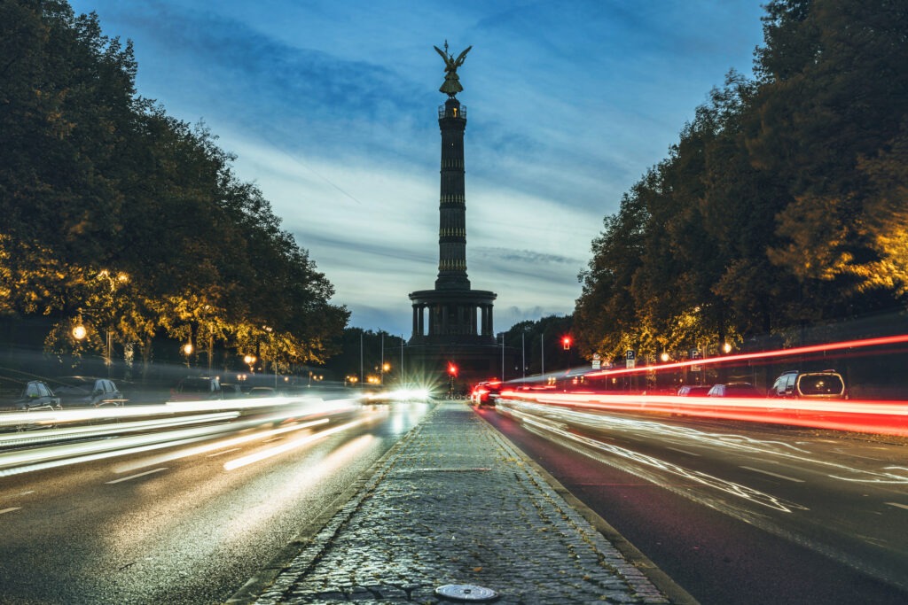 long exposure of rush hour traffic in front of Berlin victory column at sunset in autumn