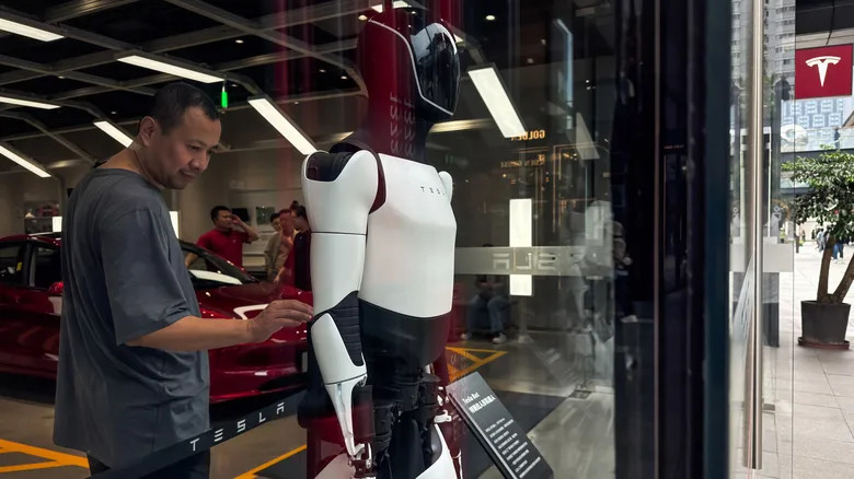 Human behind an Optimus robot.