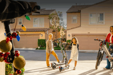 A boy and girl standing next to a scooter