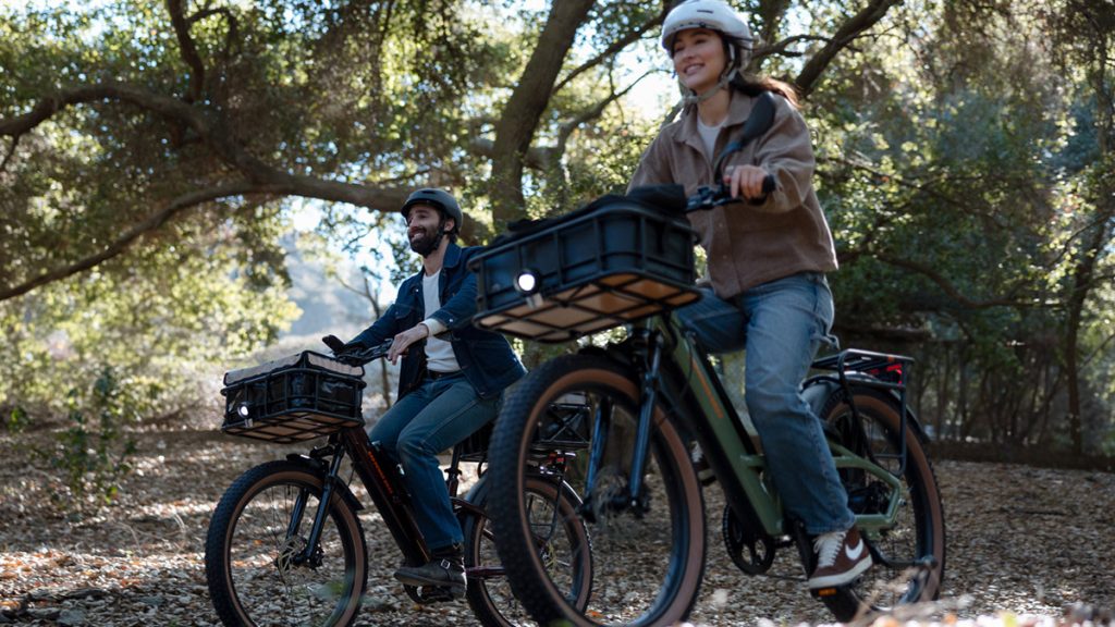 man and woman riding Rad Power e-bikes through forest