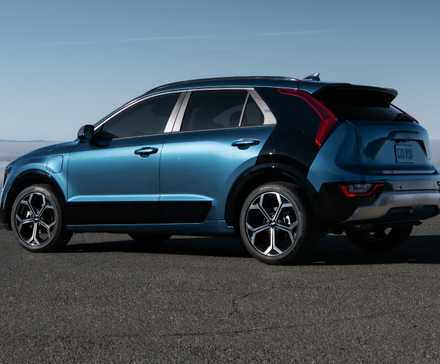 Rear three-quarters shot of a blue 2024 Kia Niro PHEV parked 