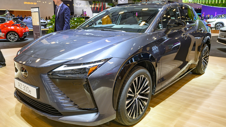 A blue-gray Lexus RZ 300e at a car show.