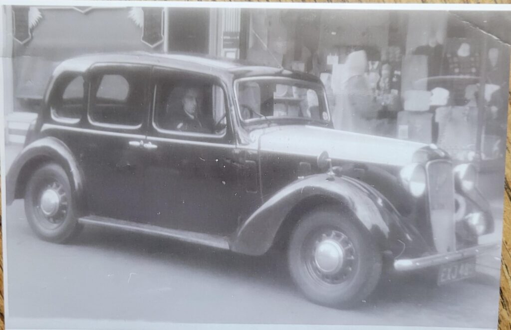 My grandfather and his taxi. England, maybe the '40s? Any idea what this car was?