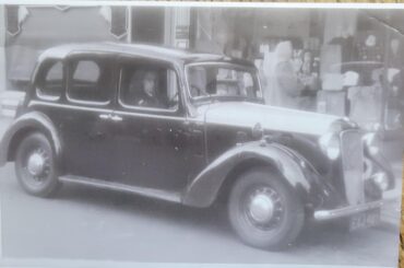 My grandfather and his taxi. England, maybe the '40s? Any idea what this car was?