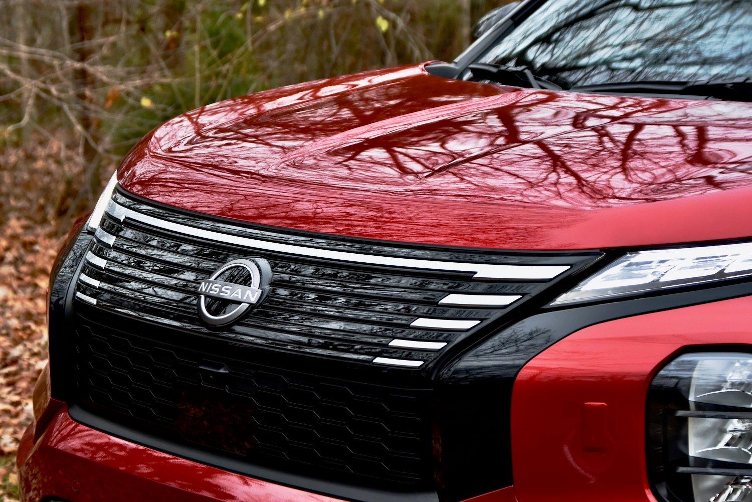 Nissan logo on the grille of a 2026 Rogue Plug-In Hybrid