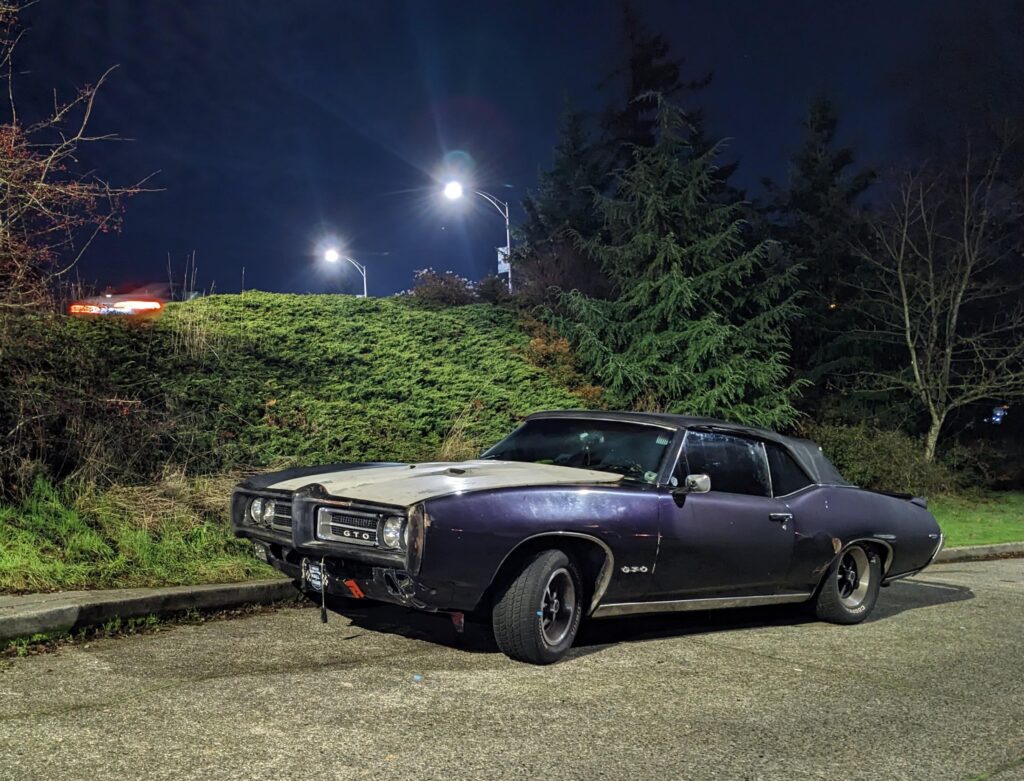 Street parked beater '69 GTO convertible