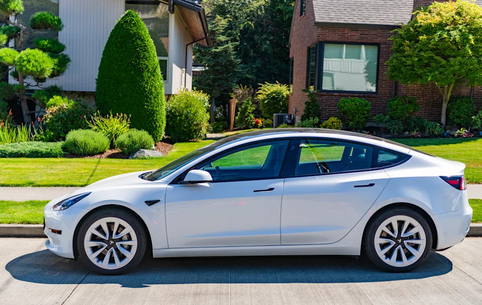 Seattle, WA, USA -July 3, 2024: tesla model 3 white near luxury house.