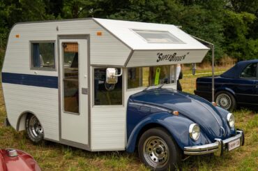 1970s "SuperBugger" Beetle RV conversion. Features kitchen with stove, sink and icebox, two pull-out beds and a two-seat dining table.