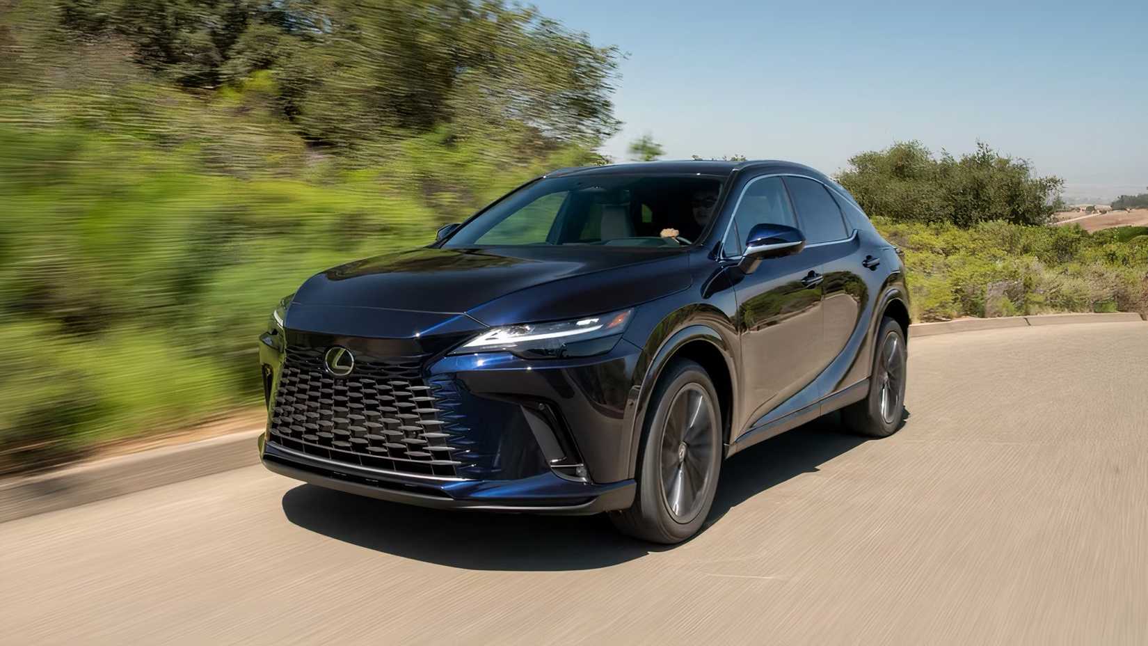 2025 Lexus RX in black driving on road