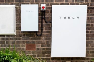 Tesla Powerwall 2 and Backup Gateway 2 installed on a brick house wall