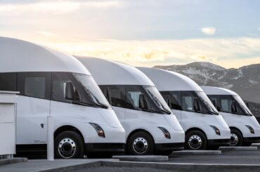 Tesla semi trucks parked in a row.