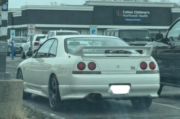 [Nissan R33 Skyline GTR] calmly chilling in a parking lot in front of Chuck e. Cheese