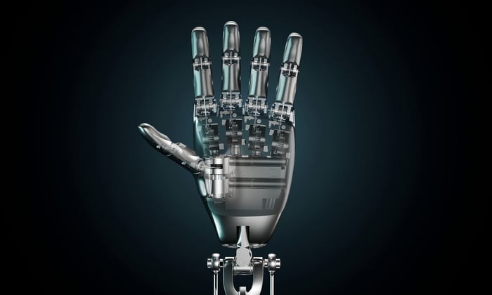 A humanoid robotic hand with fingers and thumb outstretched.