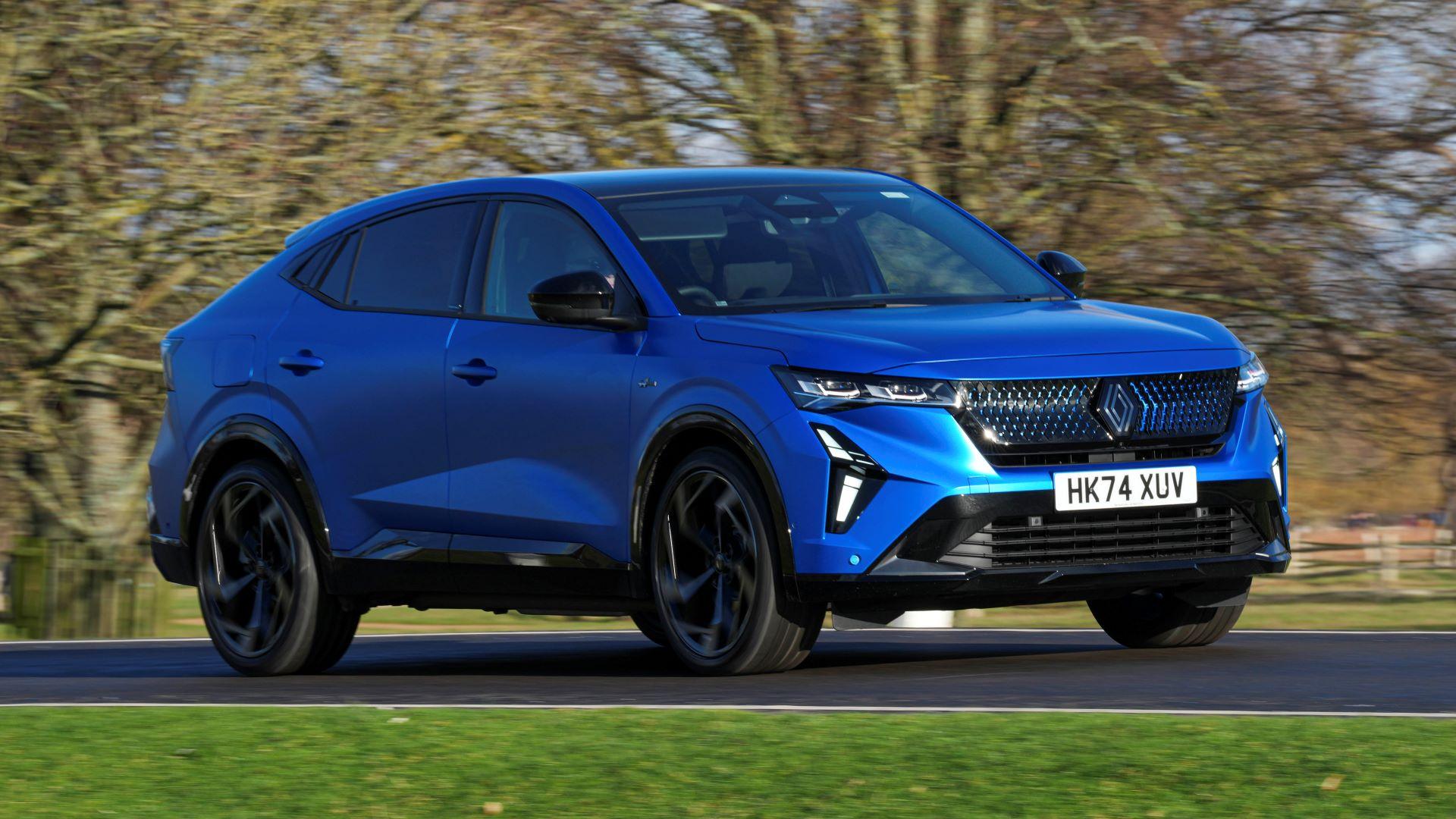 A blue Renault Rafale PHEV driving along a country road.