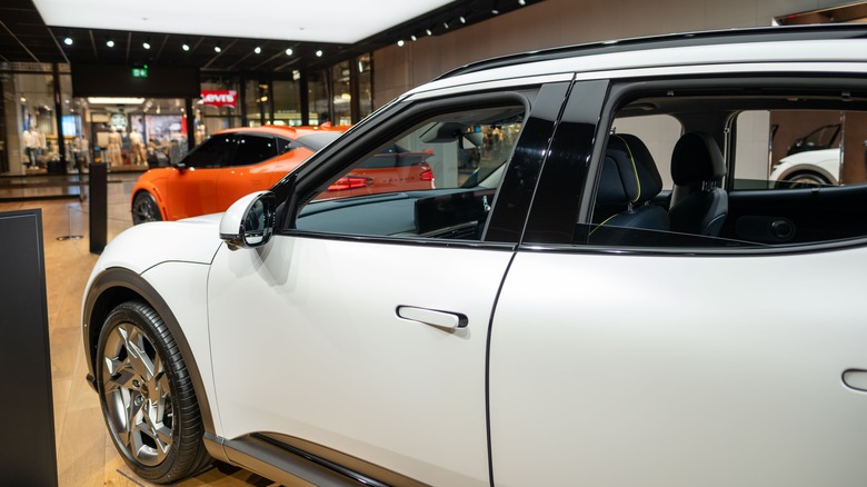 white and orange 2024 Genesis GV60s in showroom