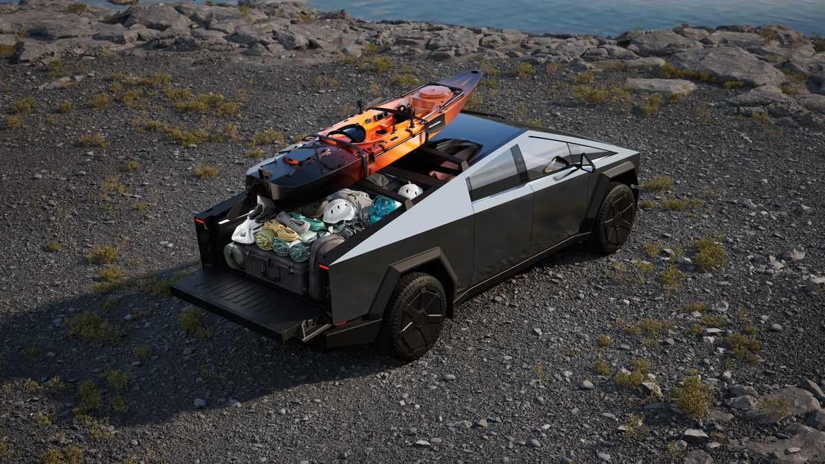 Tesla Cybertruck stainless steel electric pickup with open bed loaded with kayak and outdoor gear