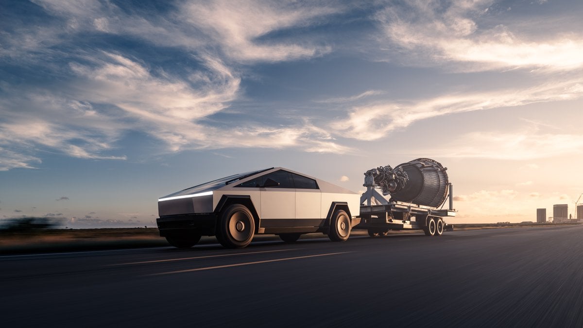 Tesla Cybertruck electric truck towing trailer with large engine at sunset on highway