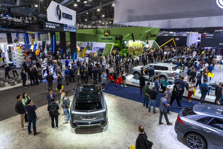 Several cars with components by Gentex Corporation are viewed as attendees also walk about a GW ...