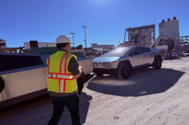 The Boring Company President Steve Davis walks by a pair of Tesla Cybertrucks at the company's ...