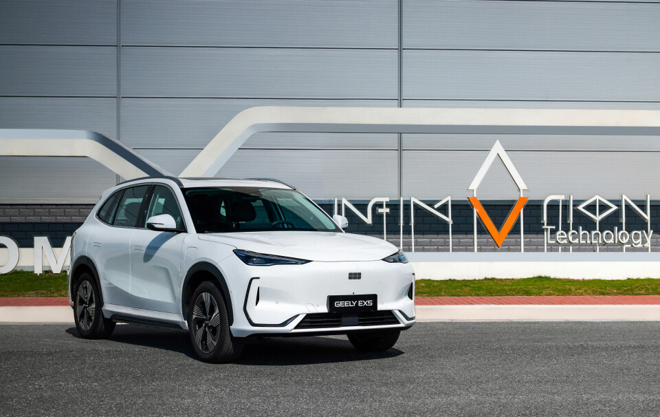 The Geely EX5 is powered by Infimotion's L402 Electric Drivetrain Unit (EDU) White Geely EX5 electric SUV parked in front of an InfiMotion Technology building.