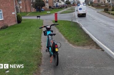 E-bike left on a path in Colchester - it is standing on a kick stand and is bright blue