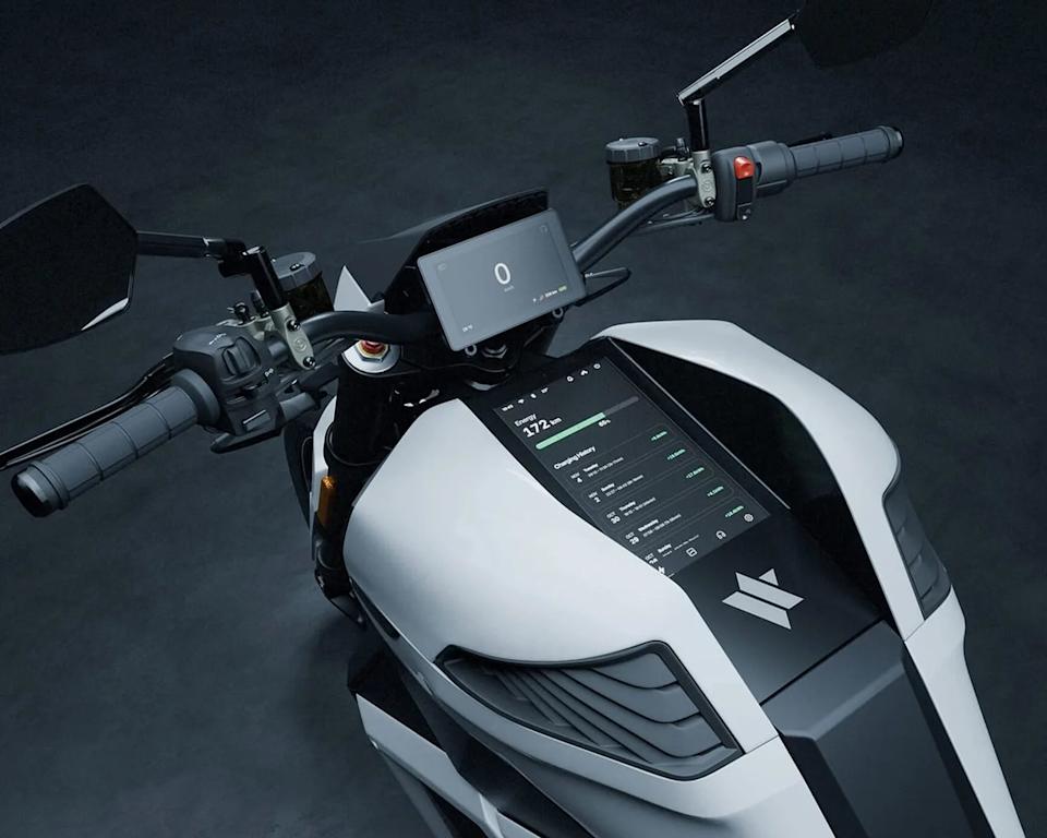White and black electric motorcycle dashboard with digital display showing energy and charging history.