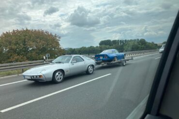 A [Porsche 928] towing a [Alpine A110] back during my vacation in Germany