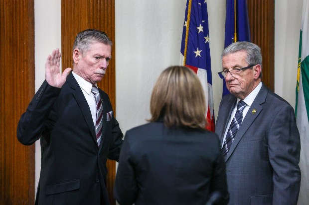 Mike Belusko is sworn in as the new vice chair of Wilkes-Barre City Council on Monday, Jan. 5, 2026, in council chambers at City Hall. Councilman Bill Barrett, now in his sixth term, holds the bible as council clerk Cathy Payne administers the oath of office. (JASON ARDAN / STAFF PHOTOGRAPHER)