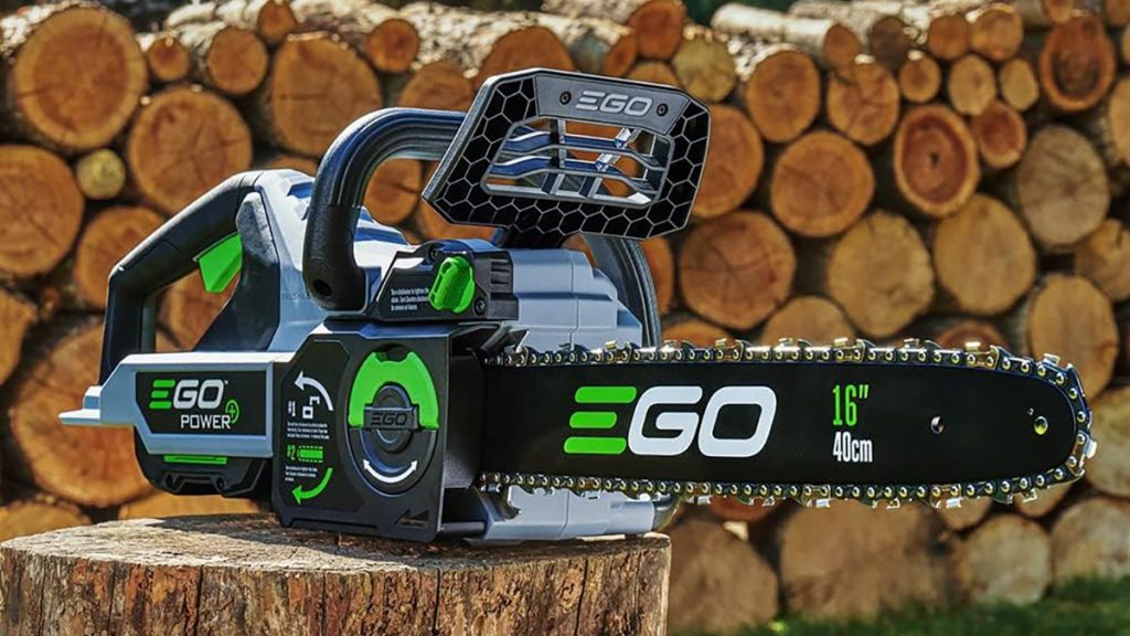 EGO Chainsaw sitting on stump in front of cut wood