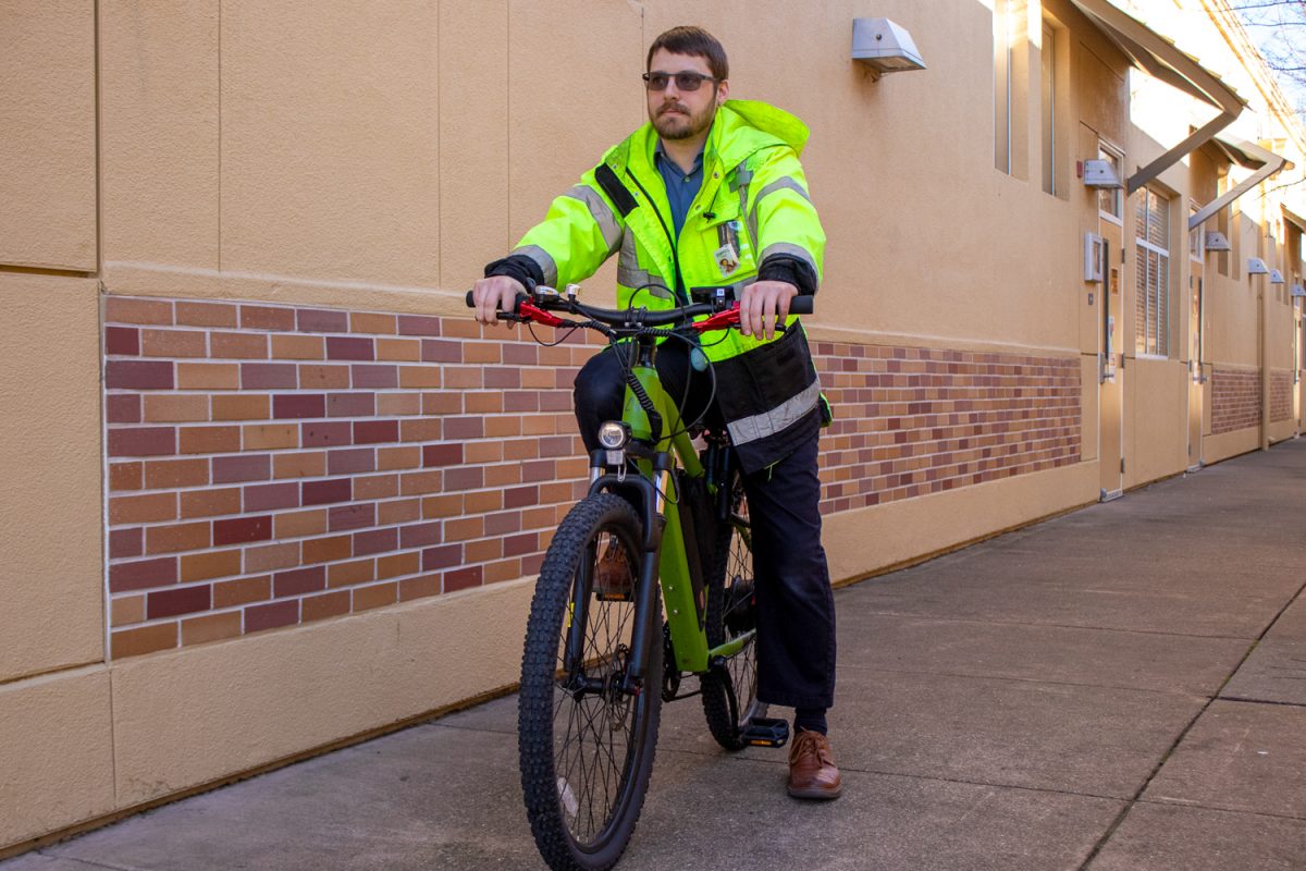 Carlmont teacher Michael O’Neall prepares to ride his electric bike off campus. California’s new 2026 e-bike safety laws affected riders like O’Neall by requiring them to have visible rear lights or reflectors at all times. The legislation also increased battery safety standards after concerns about lithium-ion fires in apartments and shared housing across the Bay Area.