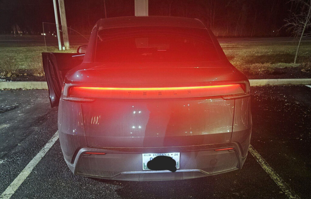 A Tesla Model Y Juniper with its rear glowing light bar. The vehicle was pulled over by a cop in Indiana.